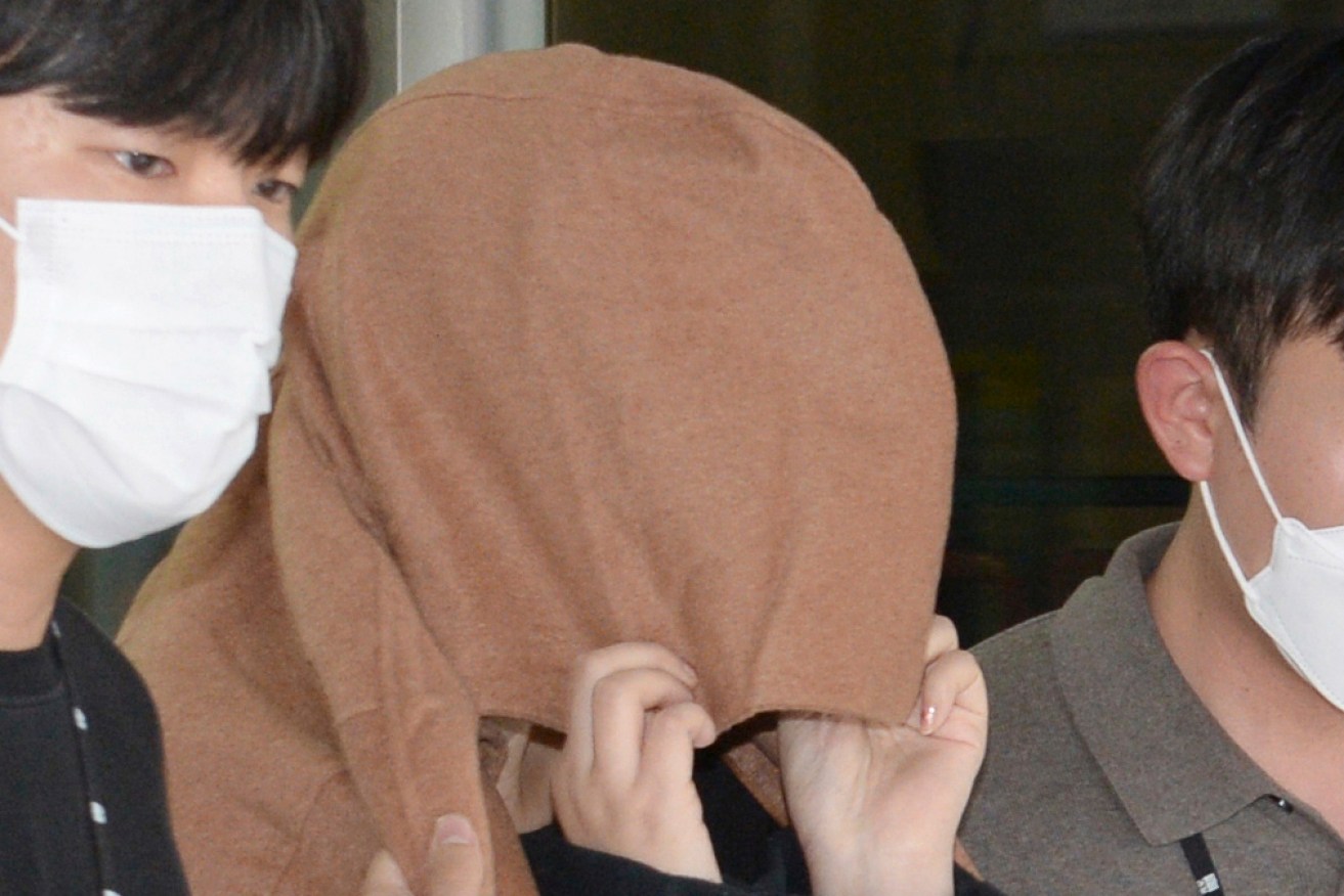 A New Zealand woman has been extradited from South Korea as the investigation into two bodies of children found in suitcases continues.