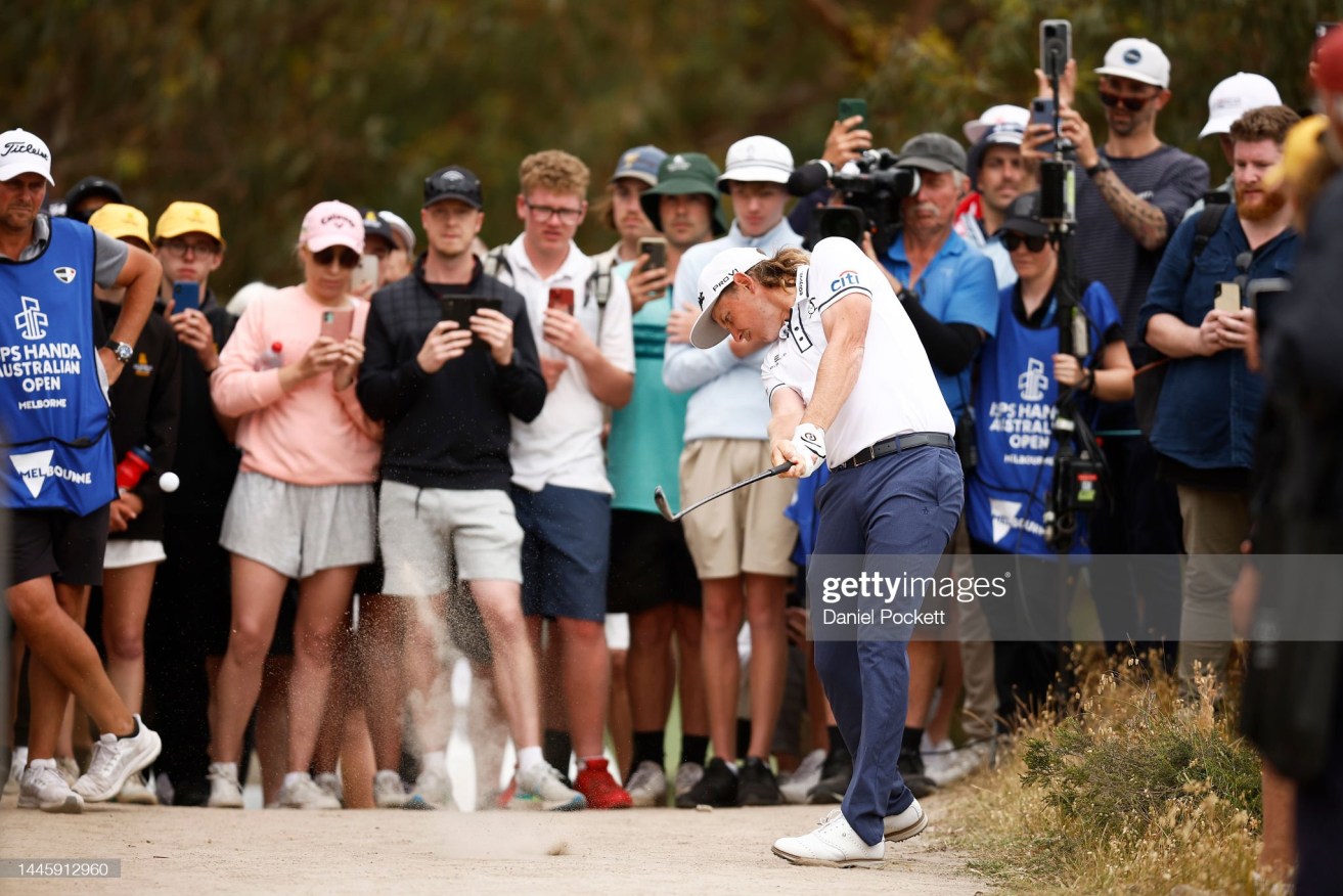 Cameron Smith plays from a path as he struggled to a one-over 71 in the first round of the Australian Open.