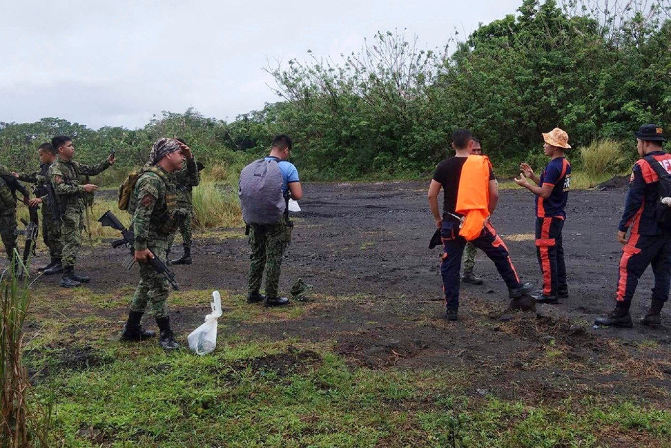Rescuers search for the wreckage of a plane that crashed in Albay province in the Philippines. 
