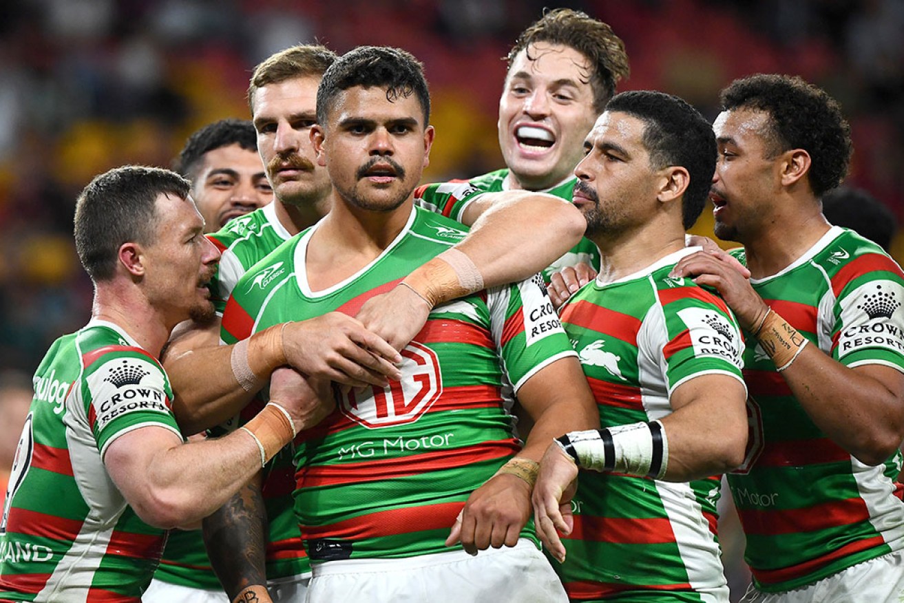 South Sydney teammates celebrate Latrell Mitchell's try in their NRL win over the Dolphins. 