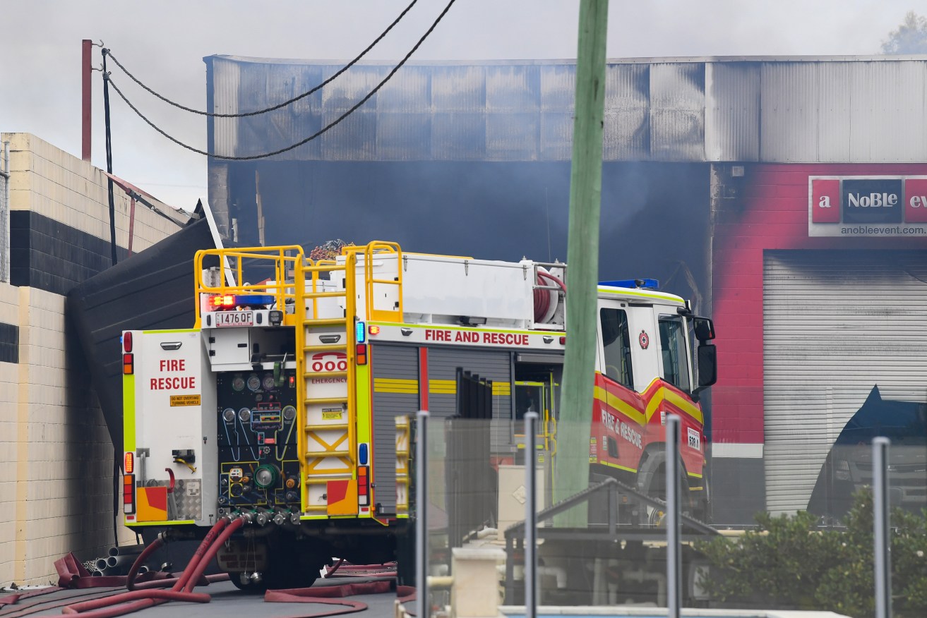 A firefighter has died overnight after she was injured in a factory fire in Brisbane.