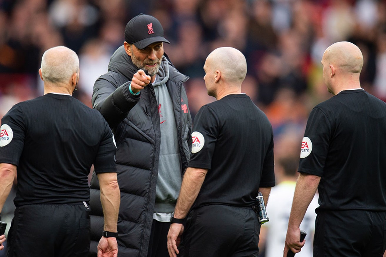 Jurgen Klopp confronts referee Paul Tierney and his assistants after Sunday's match with Tottenham.
