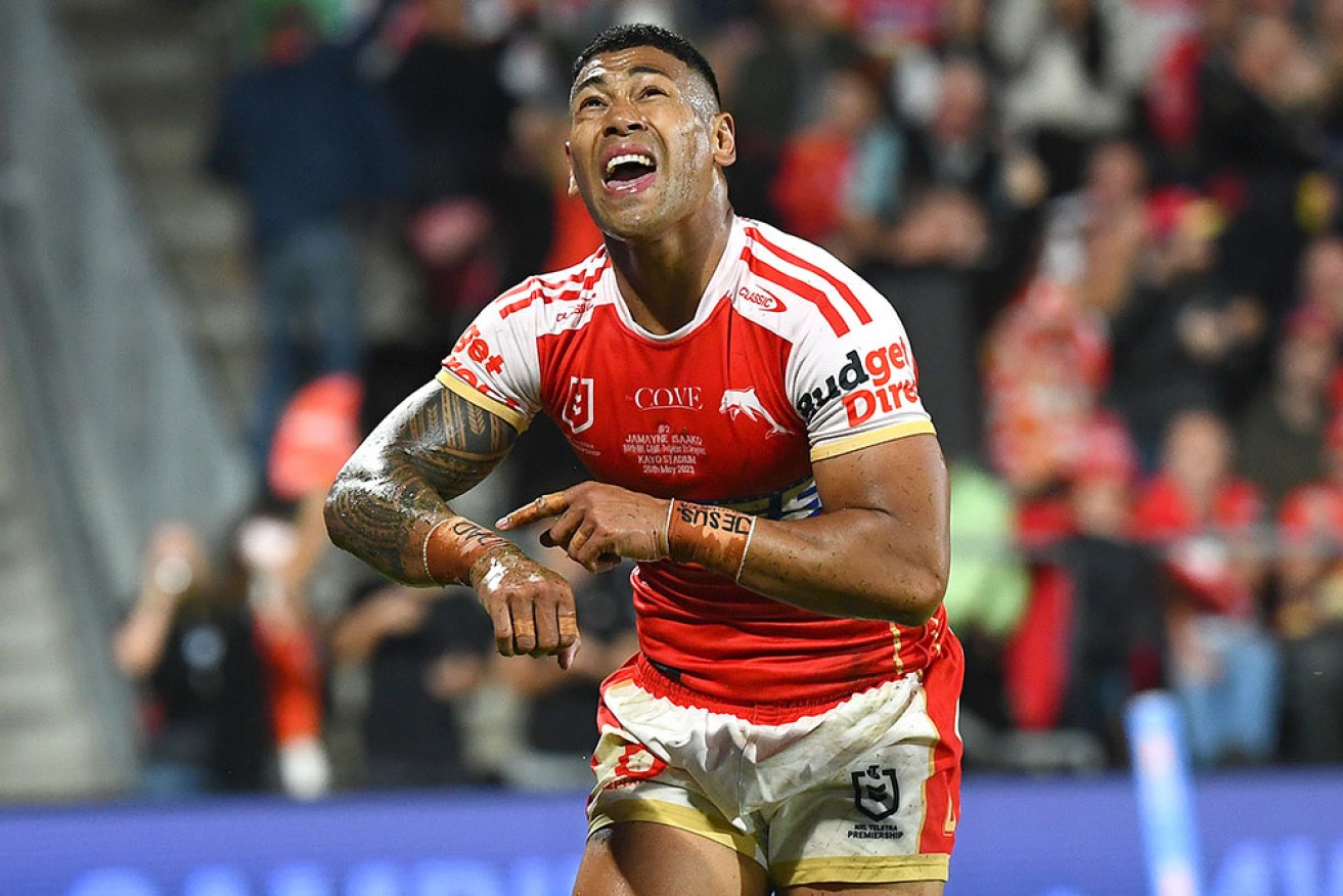Jamayne Isaako celebrates one of two tries in his 100th NRL game as the Dolphins beat the Dragons. 