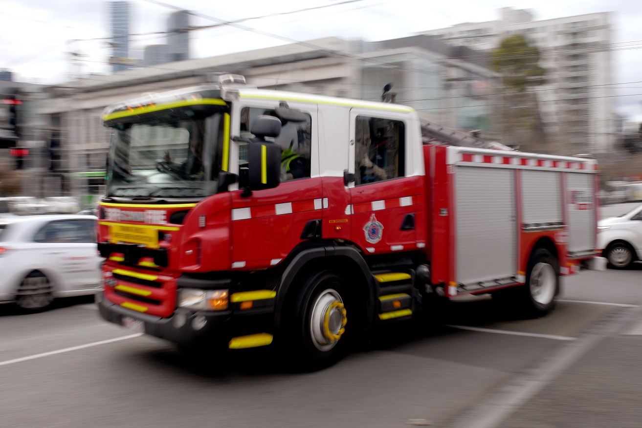 A firefighter has died while responding to a house fire in Sydney.