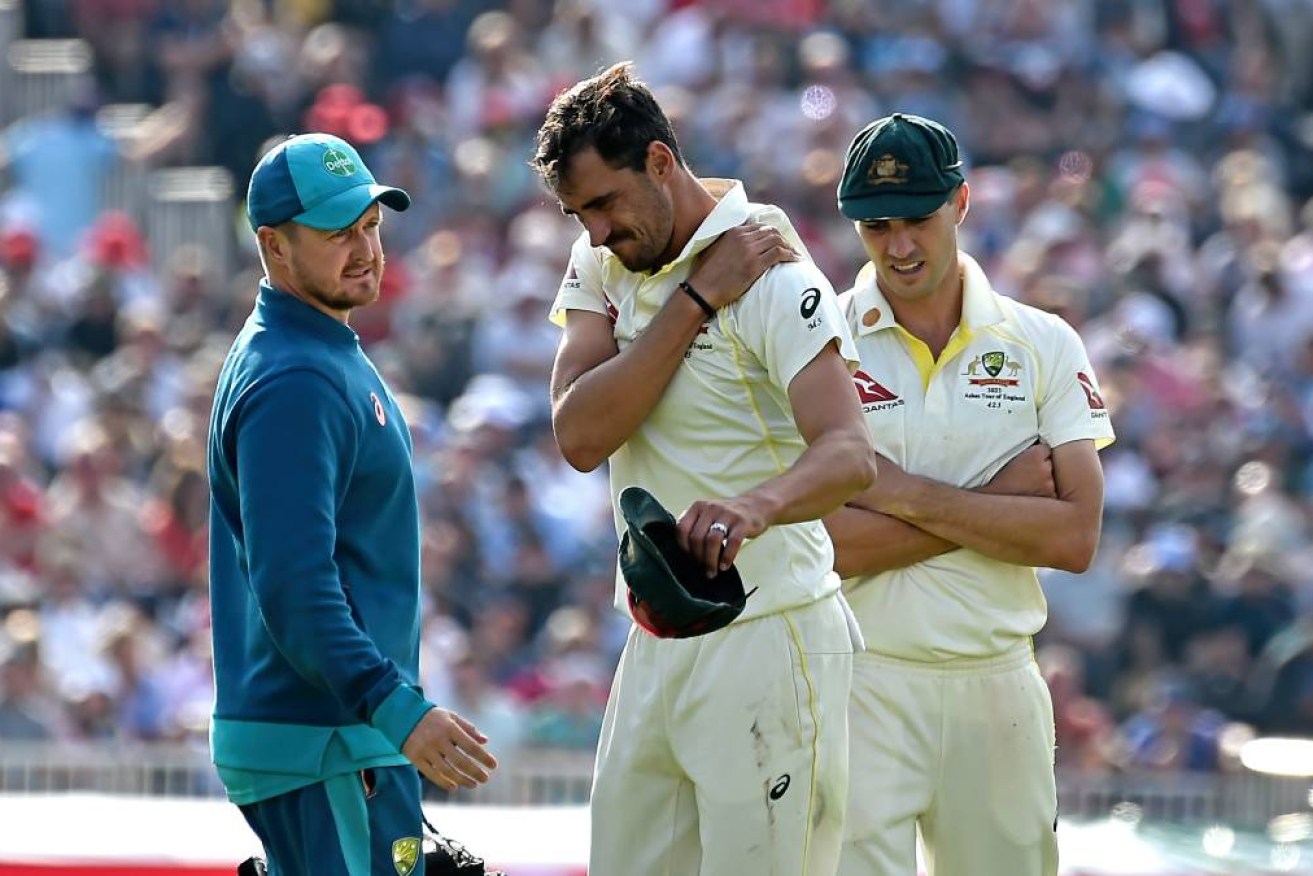 Mitchell Starc clutches his shoulder during the Ashes series, but it's his groin that has ruled him out.