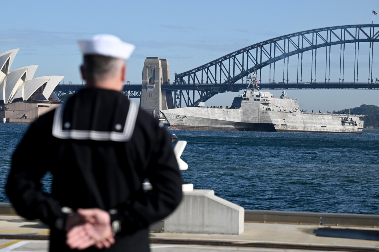 The futuristic triple-hulled USS Canberra glides into Sydney Harbour carrying best wishes from Washington.