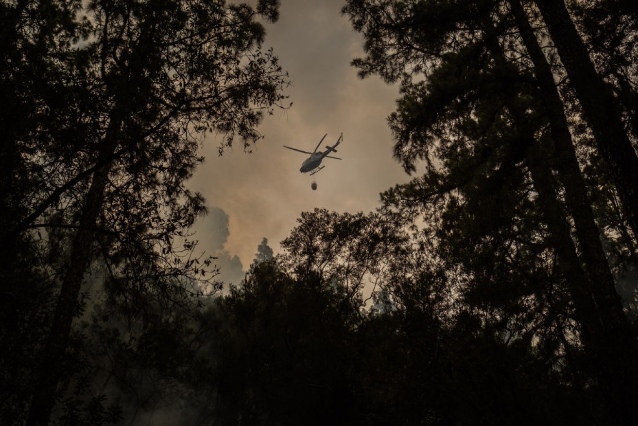 A firehawk helicopter is seen in the Aguamansa area of Tenerife, Canary Islands on Sunday. 