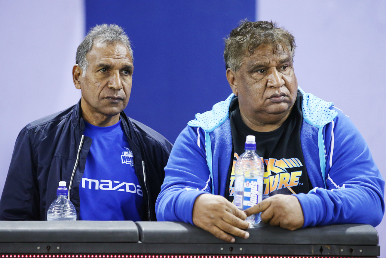 Veteran Phil Krakouer (r) says fellow Indigenous  players like brother Jim (l) bear lasting scars from their ordeal in the AFL.