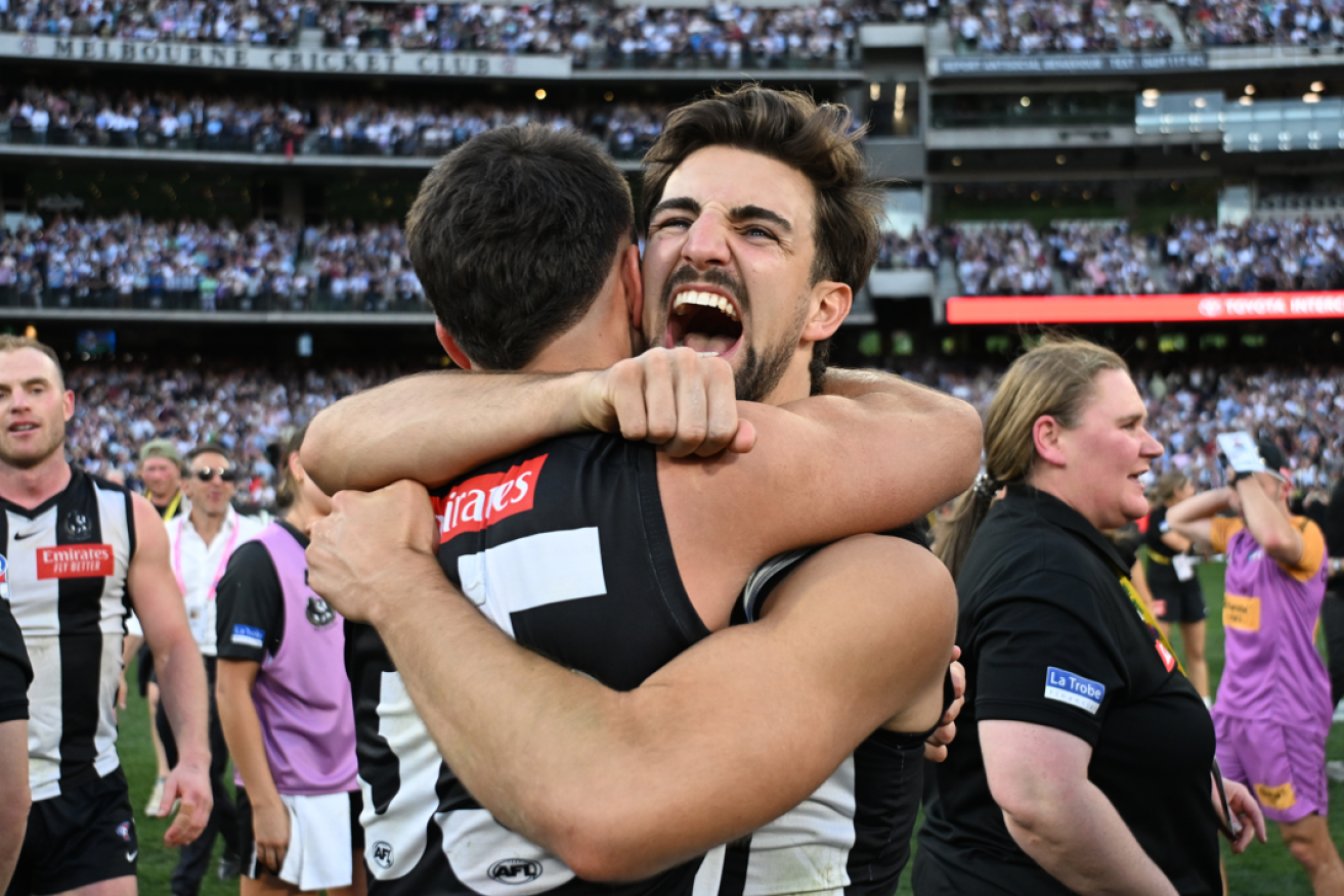 Magpie brothers Nick and Josh Daicos fall deliriously into each other's arms after Collingwood's heart-stopping victory.