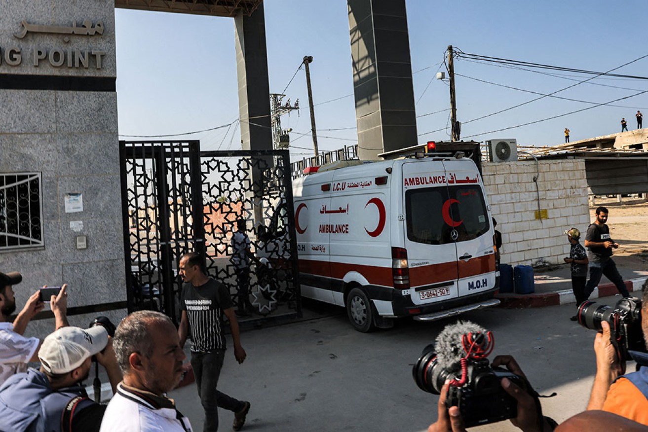 A Palestinian health ministry ambulance enters the Rafah border crossing in the southern Gaza Strip before crossing into Egypt on Wednesday.