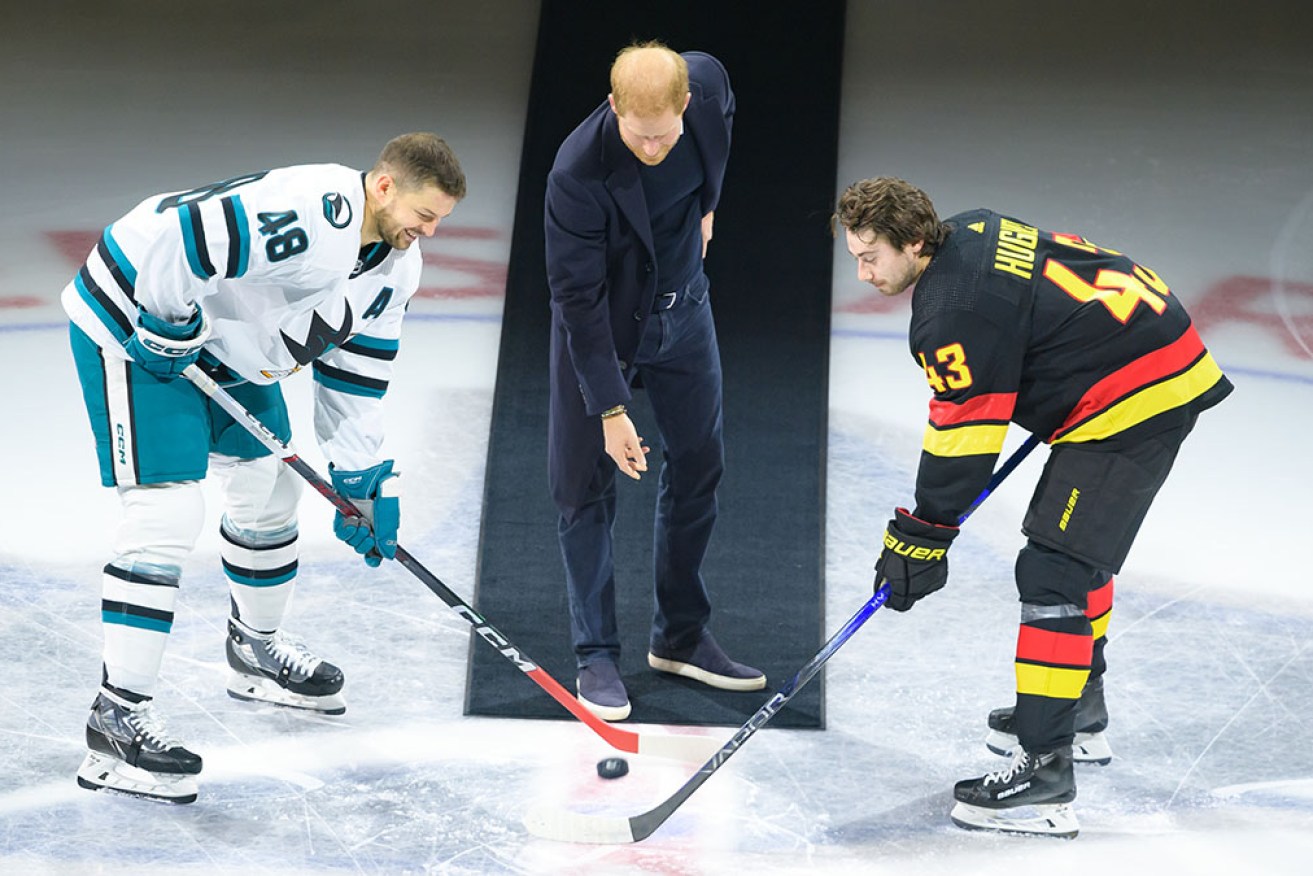 Prince Harry drops the puck with Quinn Hughes of Vancouver Canucks and Tomas Hertl of San Jose Sharks in Vancouver. 