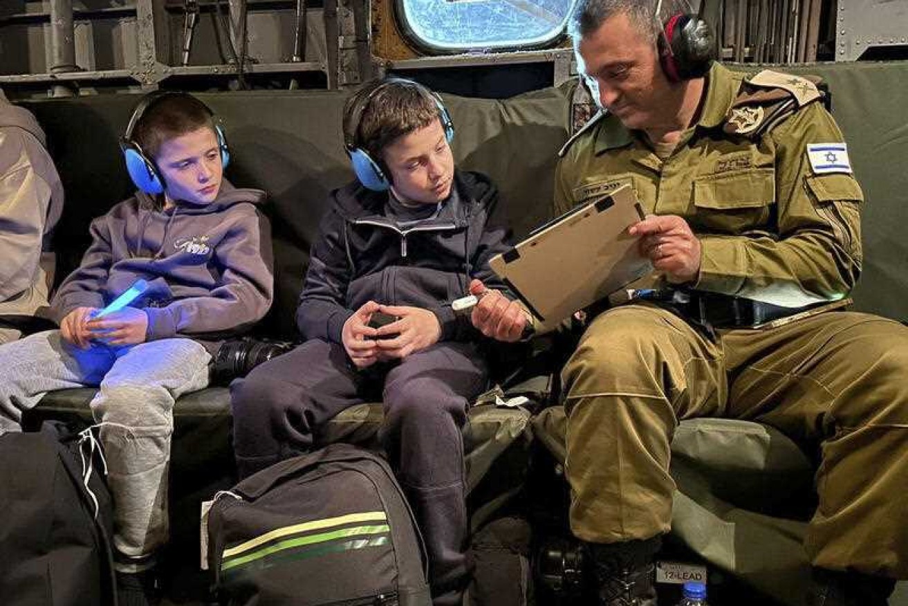 Released Israeli hostages Tal Goldstein Almog, 9, left, and his brother Gal, 11 return to Israel in an IAF helicopter.