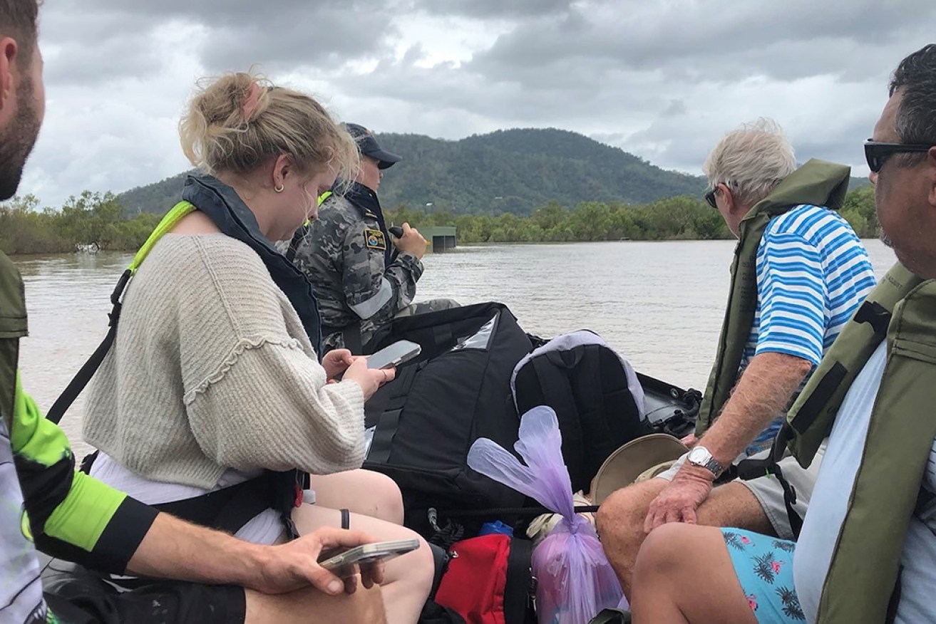 Hundreds of people in far north Queensland have been rescued by boat after being isolated by floods.