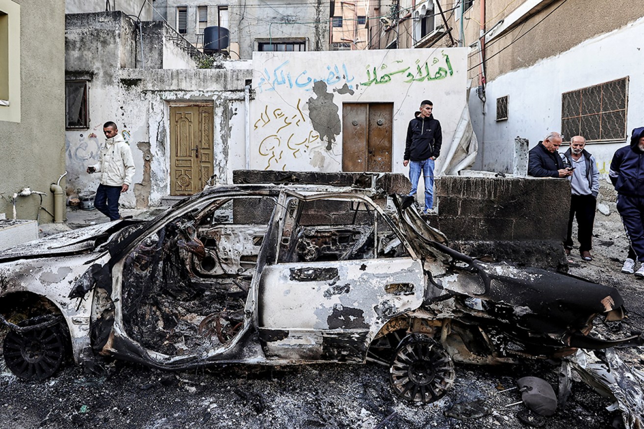 Palestinians inspect a burnt vehicle after an Israeli raid in the Nur Shams camp for Palestinian refugees near the northern city of Tulkarm in the occupied West Bank.