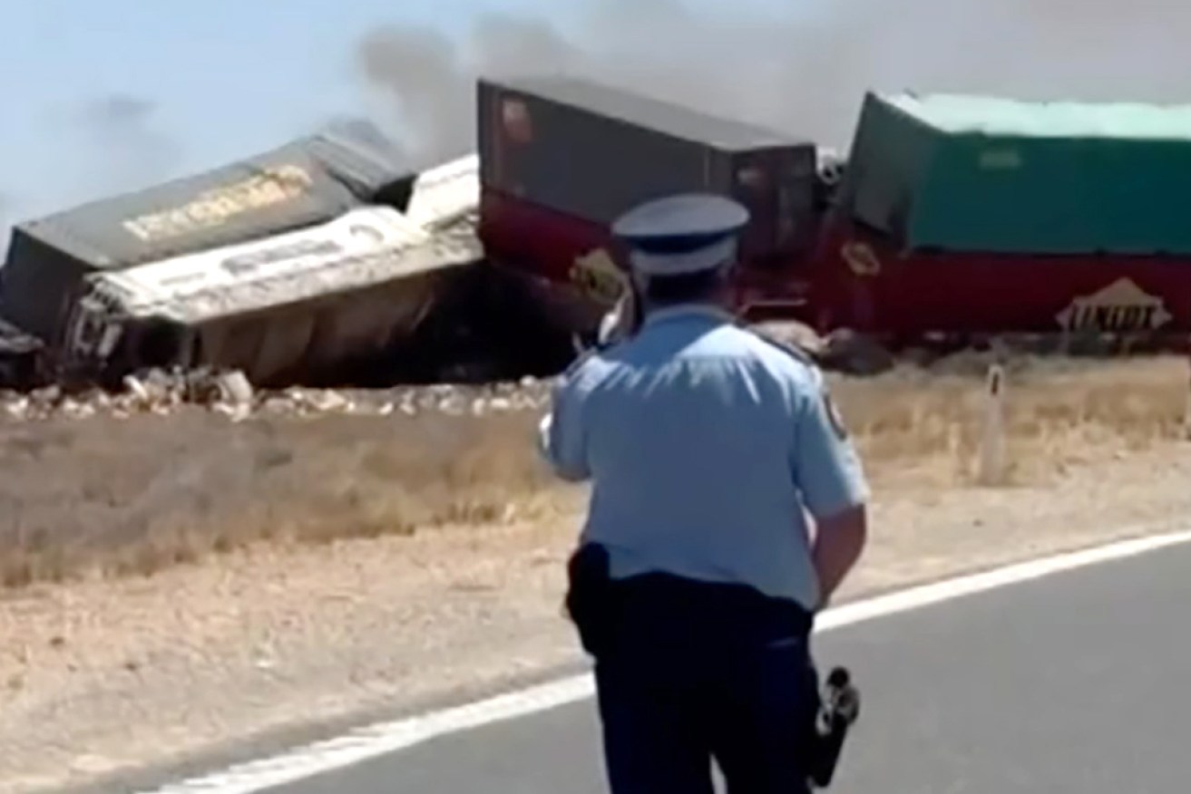 Investigators have charged a truck driver after two train drivers were killed in a collision.