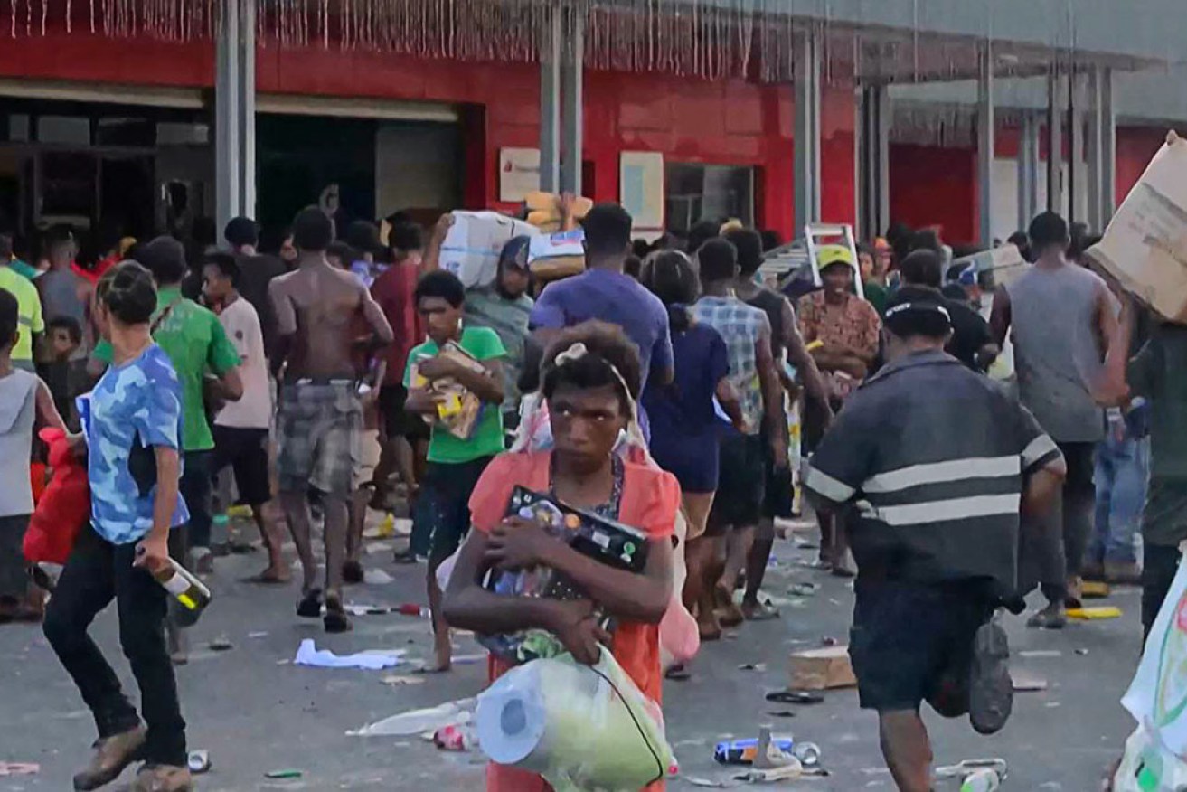 AFPTV video footage taken on Wednesday shows people looting in Port Moresby. 
