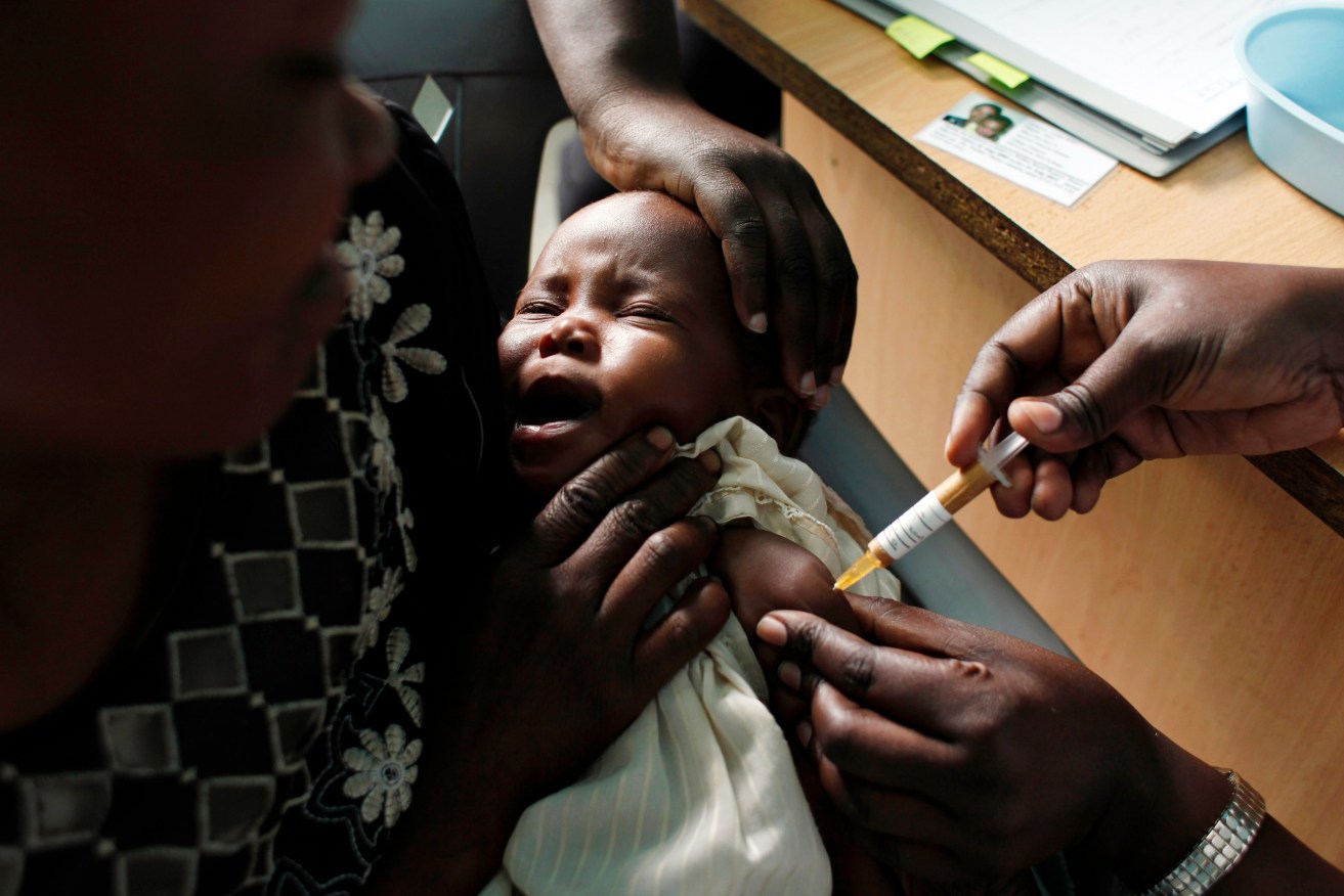 A baby receives the new malaria vaccine.  