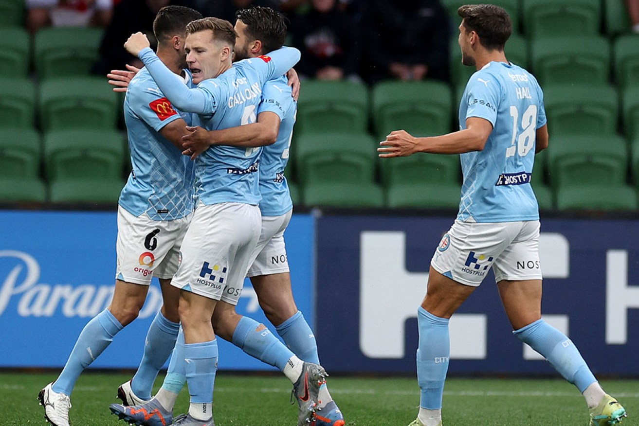 Melbourne City teammates mob Terry Antonis after his early goal on Thursday night.  