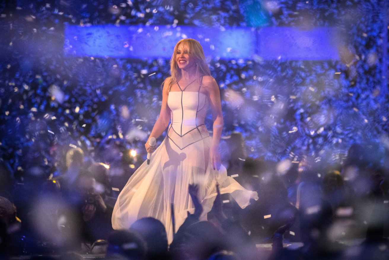 Kylie Minogue is a vision in white as she concludes her three-hit set in London.