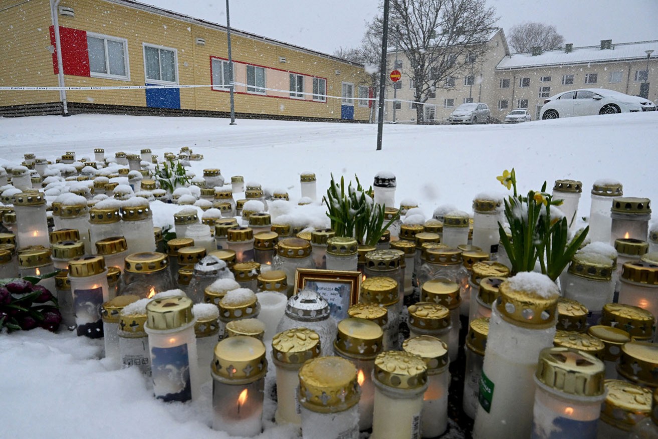 Mourners in Finland have placed candles and flowers at the scene of a deadly school shooting.