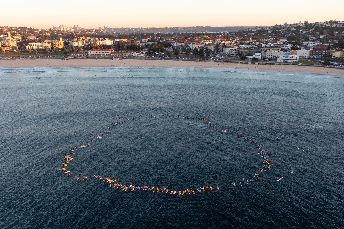 Paddleboarders formed a heart to remember the six lives lost in the Bondi Junction stabbing attack.