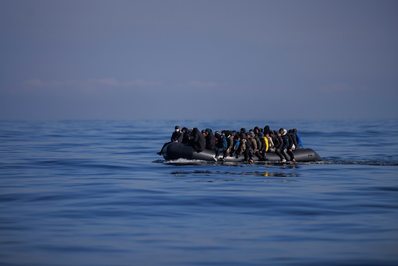 An inflatable dinghy carrying about 65 migrants crosses the English Channel in March.