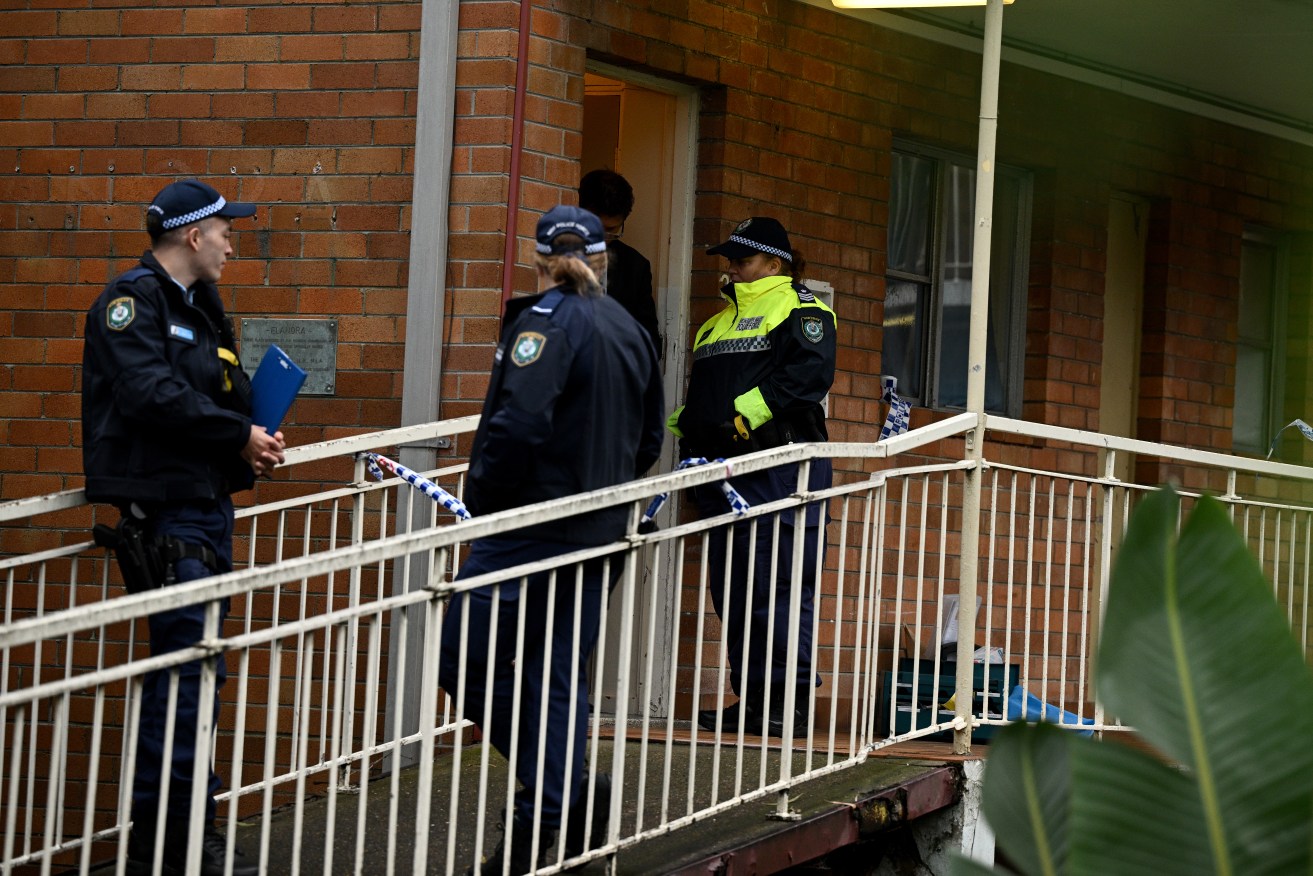 Two men are facing drug charges after the body of a woman was found in a Sydney unit.