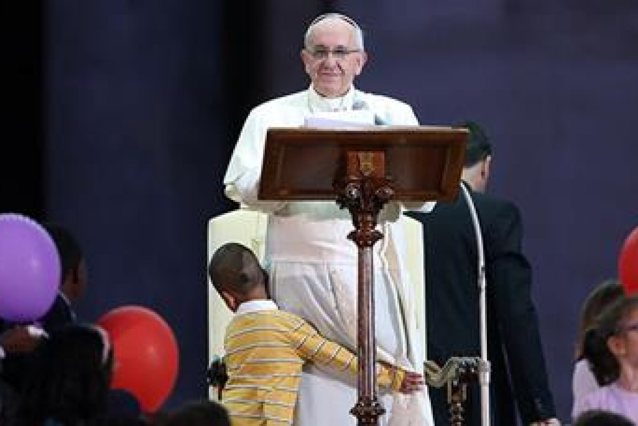 Beautiful moment ... former orphan boy Carlos hugs Pope Francis.