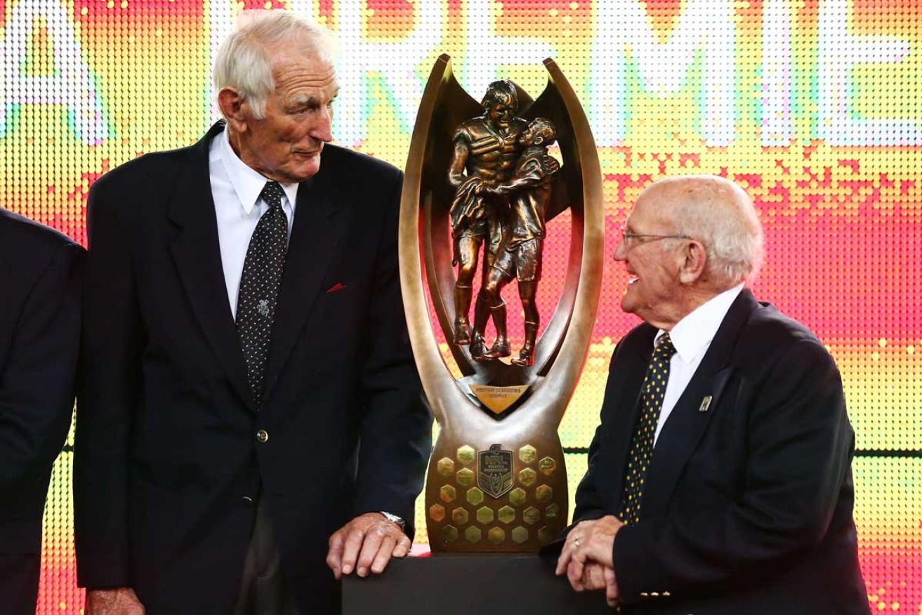 Norm Provan (left) and Arthur Summons with the NRL trophy that bears their names, at the 2013 grand final.