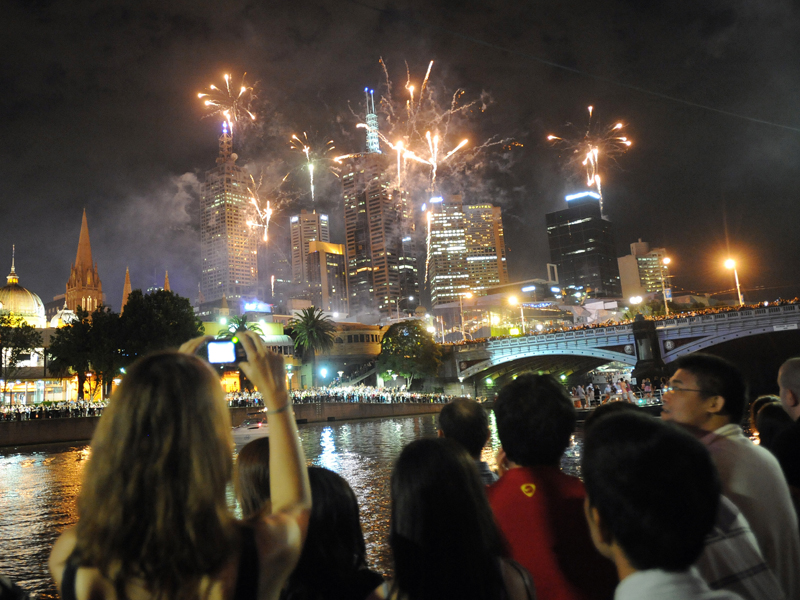 Melbourneans watch the fireworks display over the city