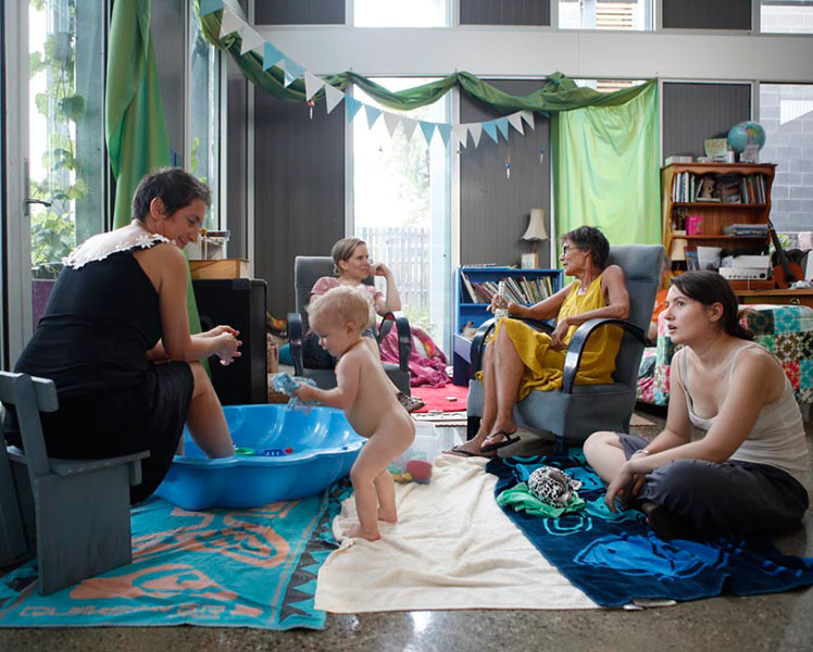 Residents of all ages relax in a communal area at Murundaka. Source: Chris Grose.