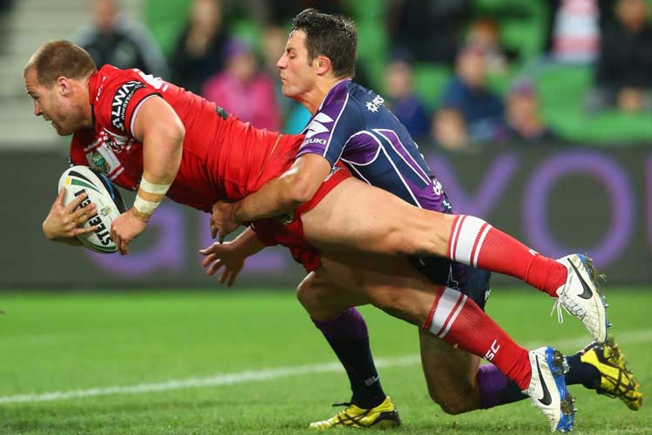 Trent Merrin of the Dragons dives to score a try despite the best efforts of Cooper Cronk. Photo: Getty