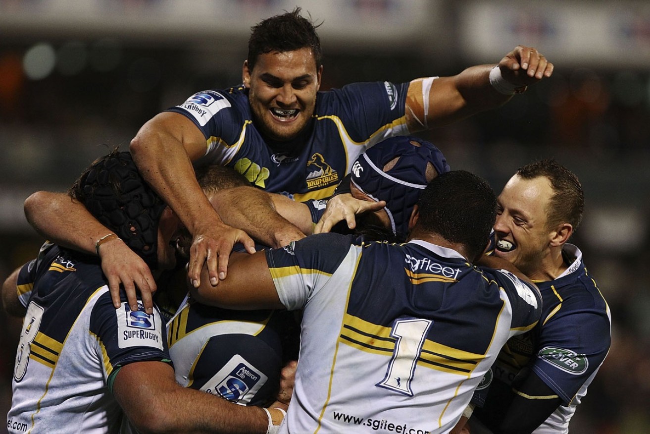 The Brumbies celebrate a try against the Sharks. Photo: Getty