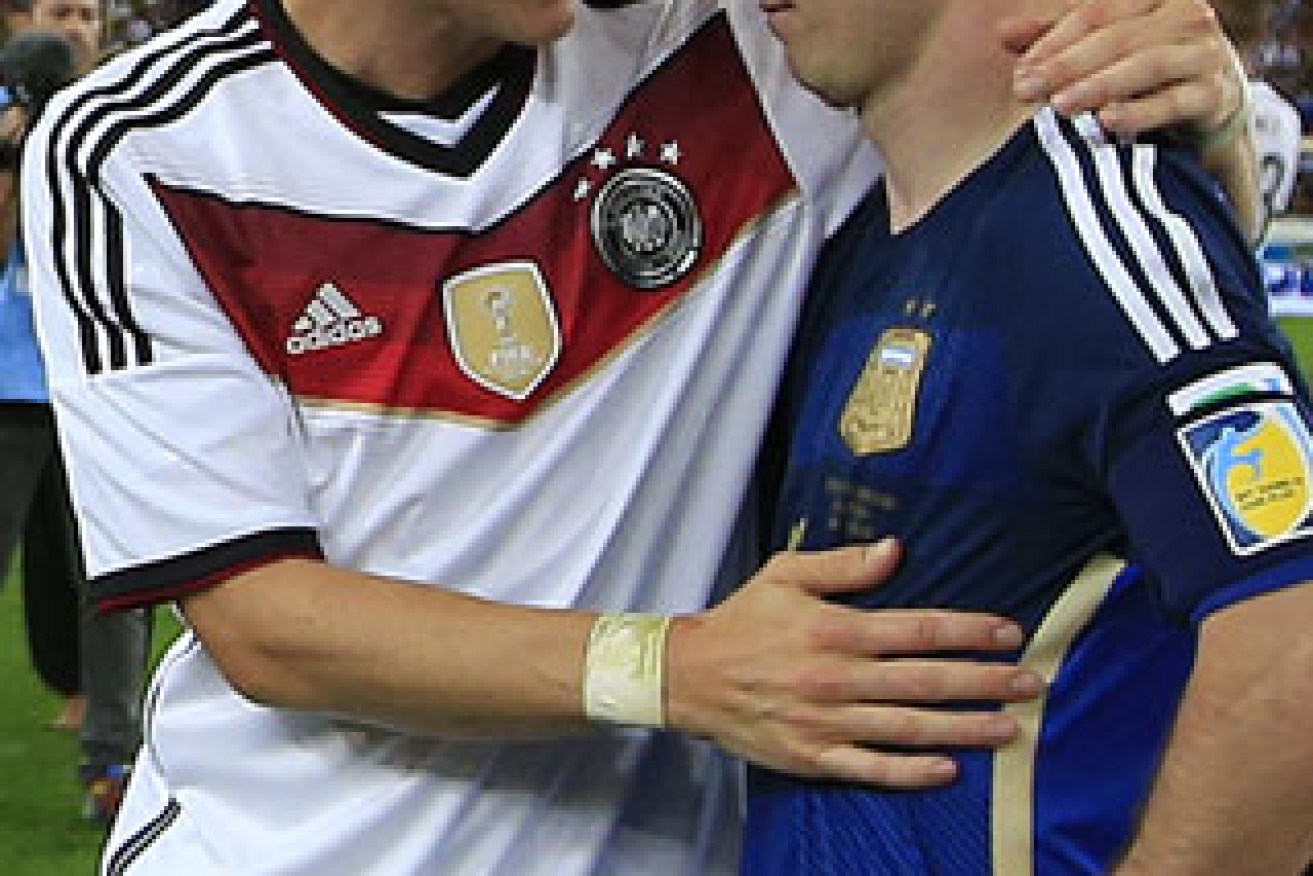 Lionel Messi is consoled by Bastian Schweinsteiger. Photo: Getty