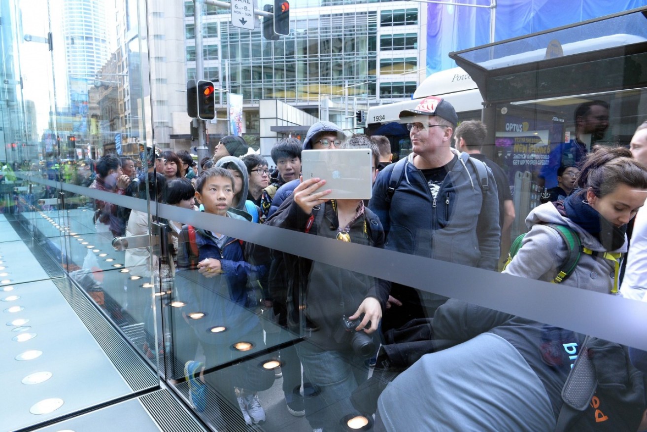 Consumers line up outside the Apple store in Sydney.