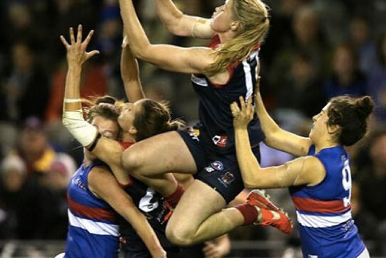 Tayla Harris takes a speccy for the Demons in this photo taken by Wayne Ludbey of the Herald Sun.