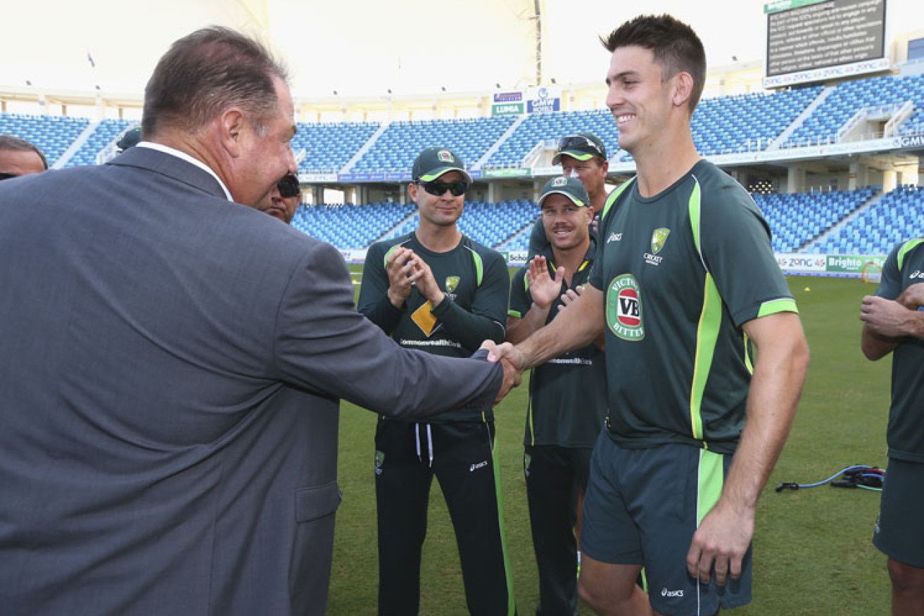 Former Test batsman Geoff Marsh presents his son Mitchell with his baggy green cap before play. Photo: Getty