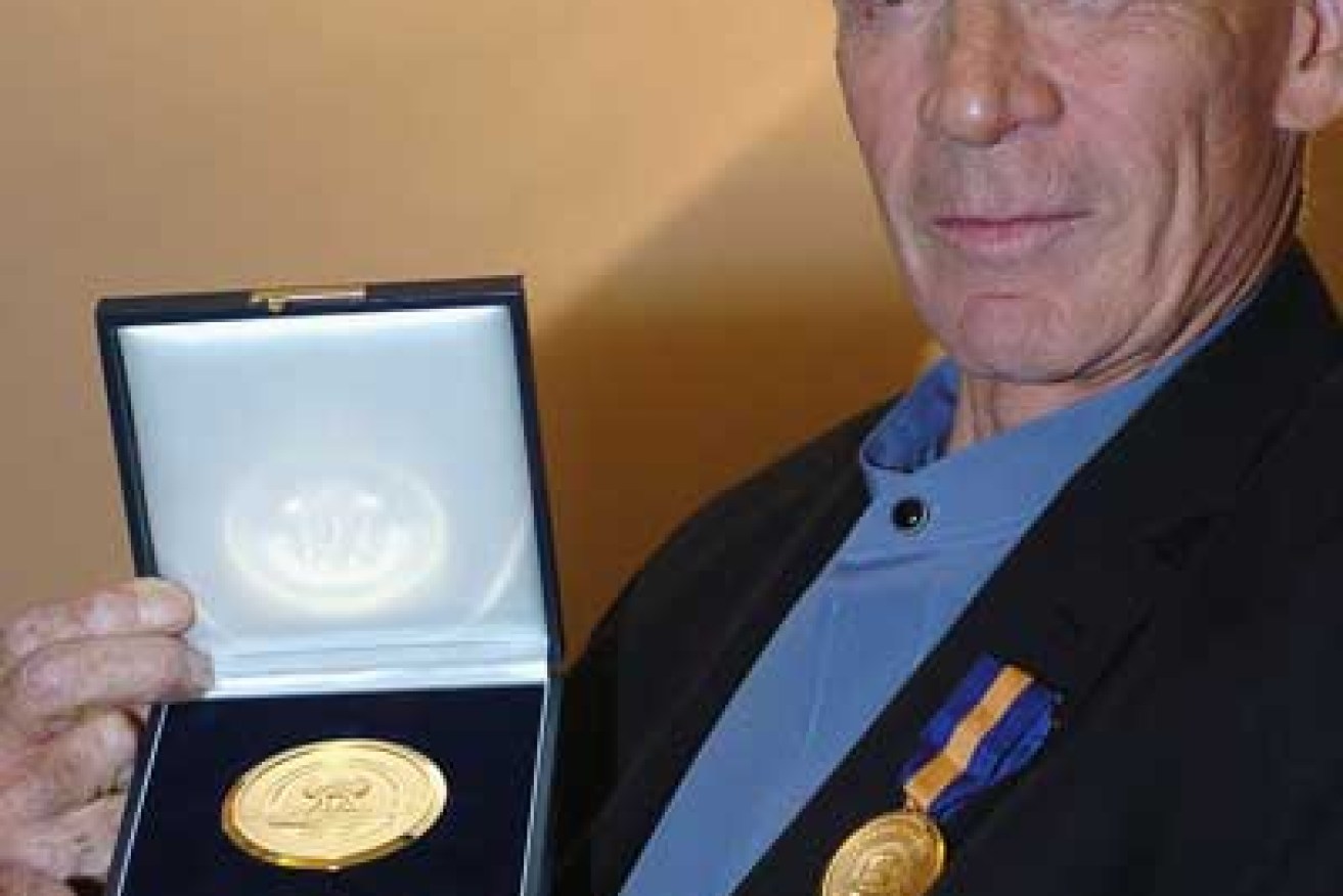 Johnny Warren in 2004 with his FIFA Centennial Order of Merit award. Photo: Getty