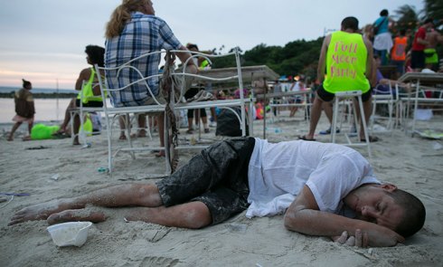 A reveller collapses after a night of partying. 
