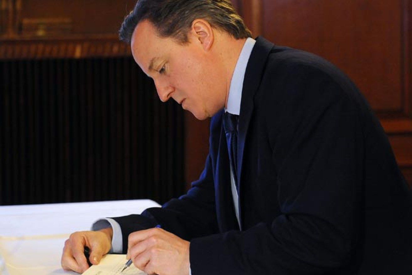 David Cameron shows his true colours when signing official documents.
