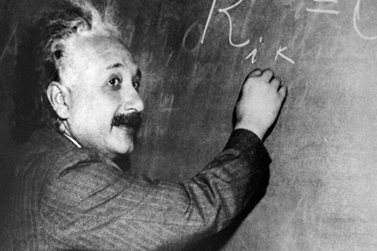 The real Albert Einstein ponders his calculations at the chalkboard.
