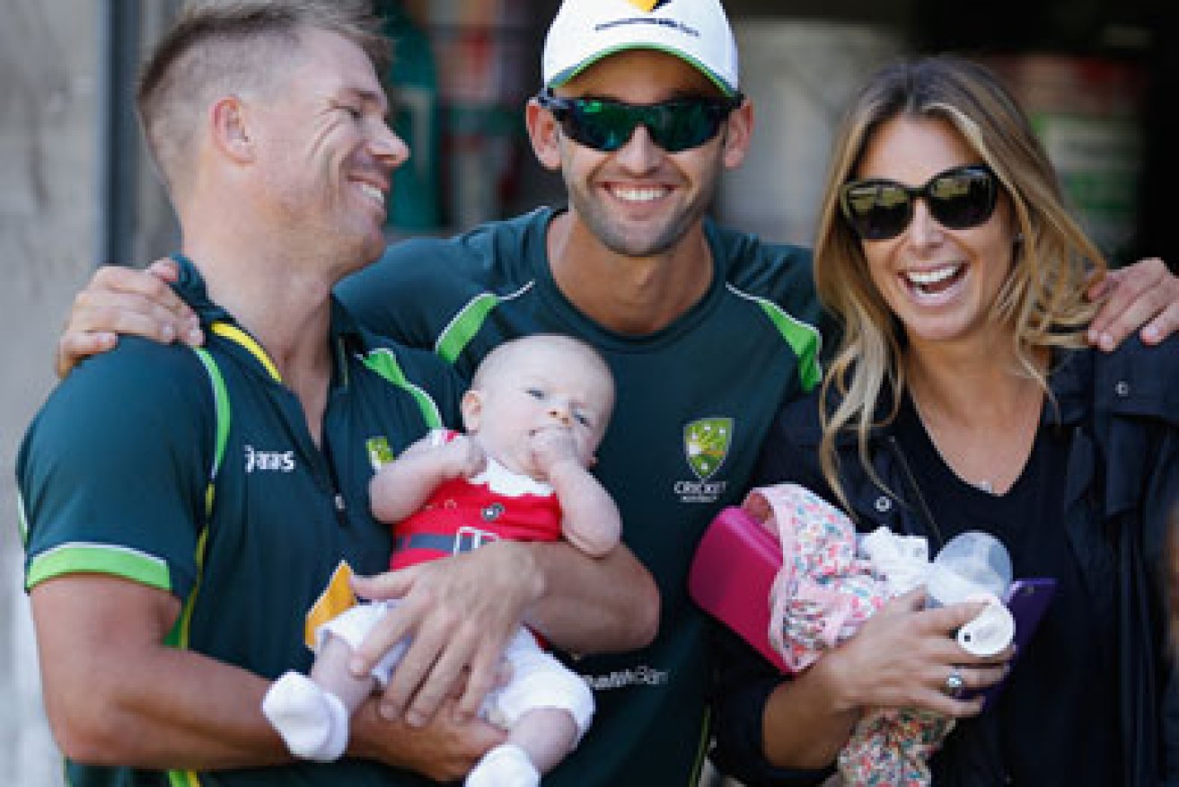 All smiles in the Australian camp. Nathan Lyon (C) crashes a photo shoot with Dave Warner, daughter Ivy and fiancee Candice Falzon. Photo: Getty