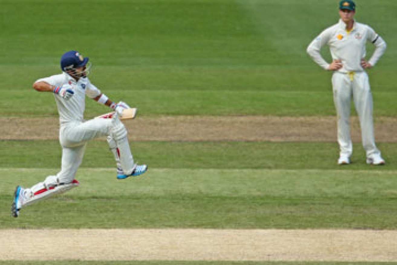 ... before posting his century, much to the joy of Australian captain Steven Smith. Photos: Getty