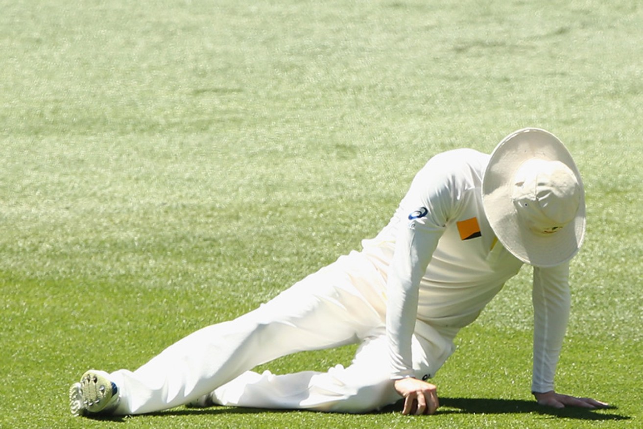 Michael Clarke goes down with his right hamstring injury yesterday. Photo: Getty