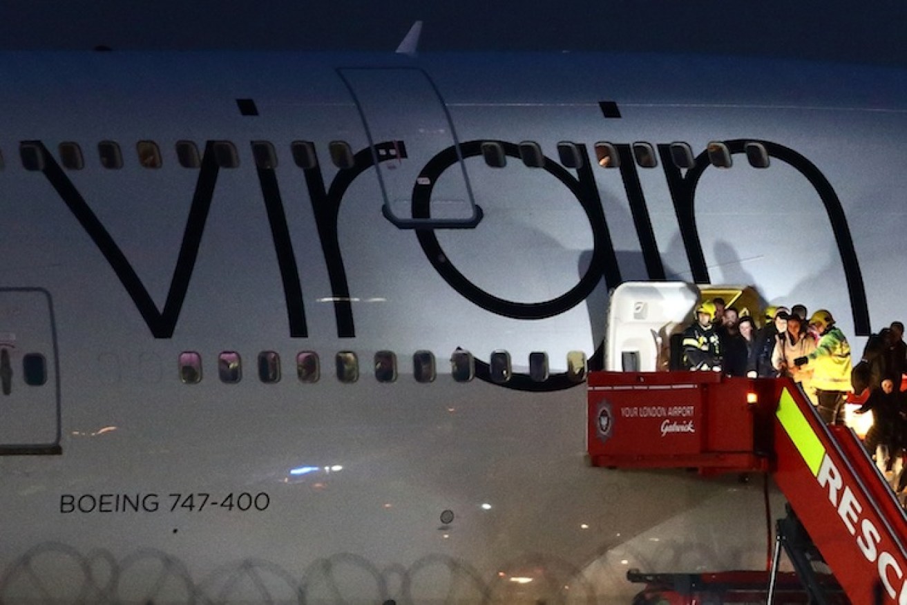 Passengers disembark the plane. Photo: Getty