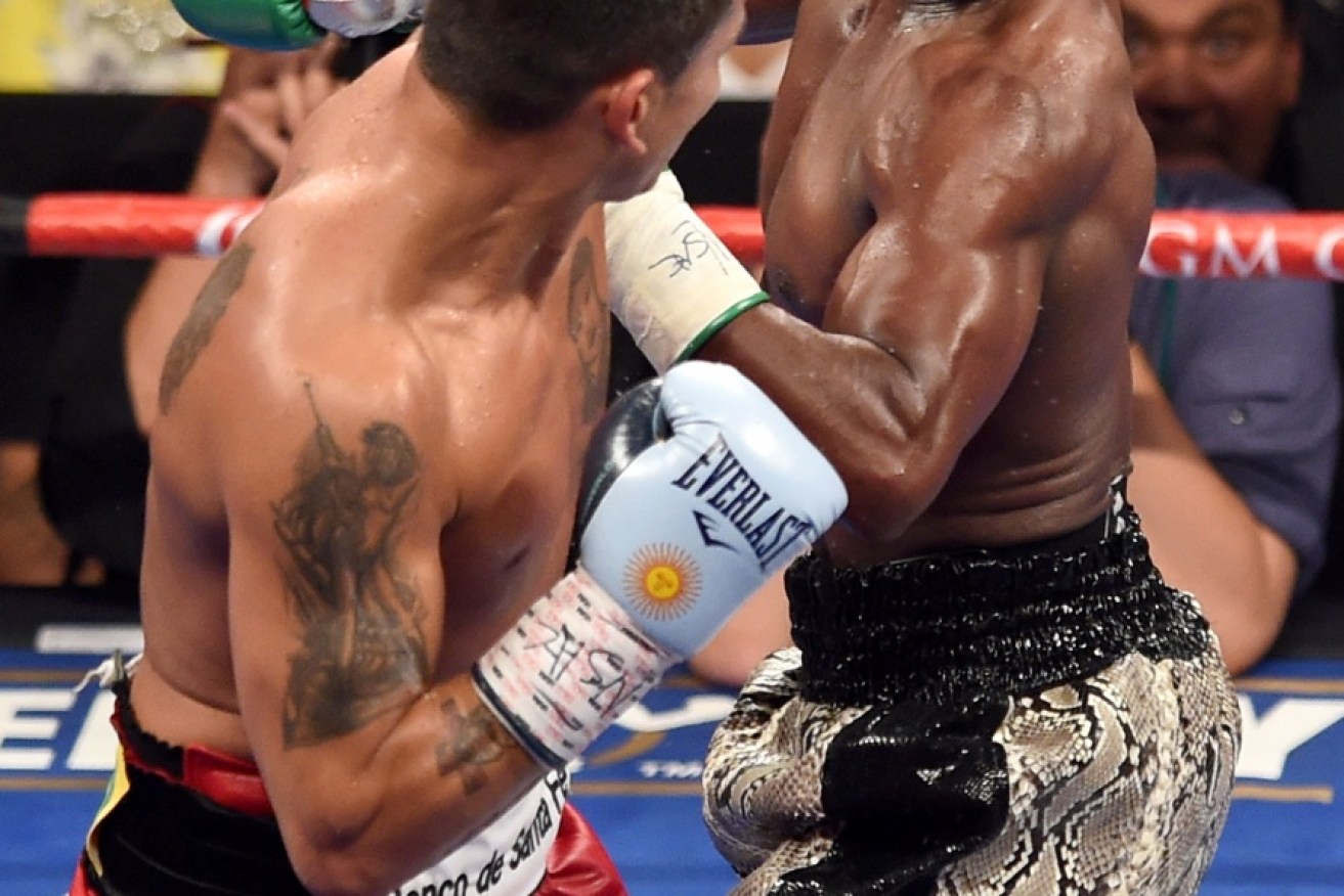 Floyd's handed out many hits during his career - but here, he takes one in his last bout. Photo: Getty