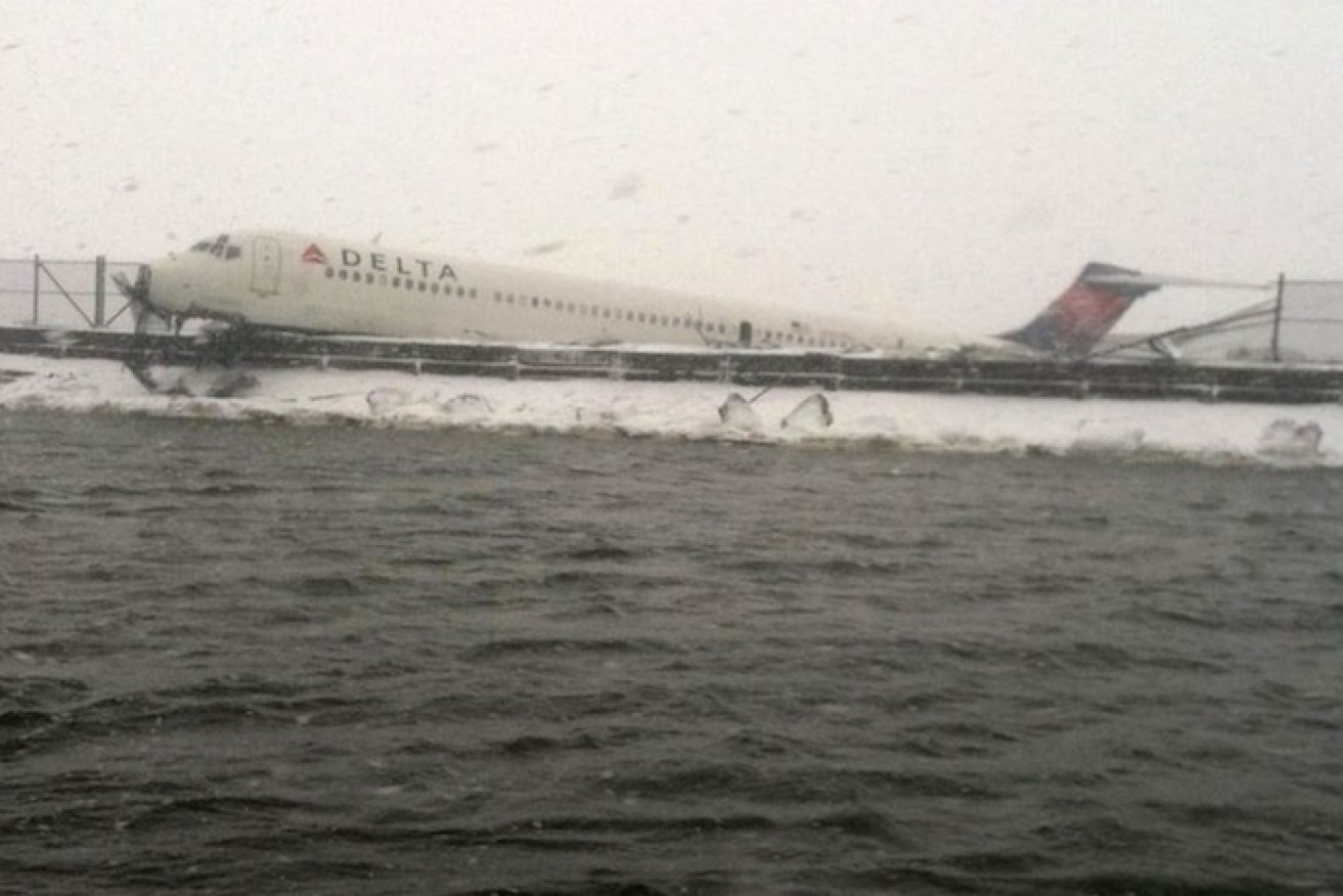 The Delta plane rests on a safety fence at La Guardia airport. Photo: AAP