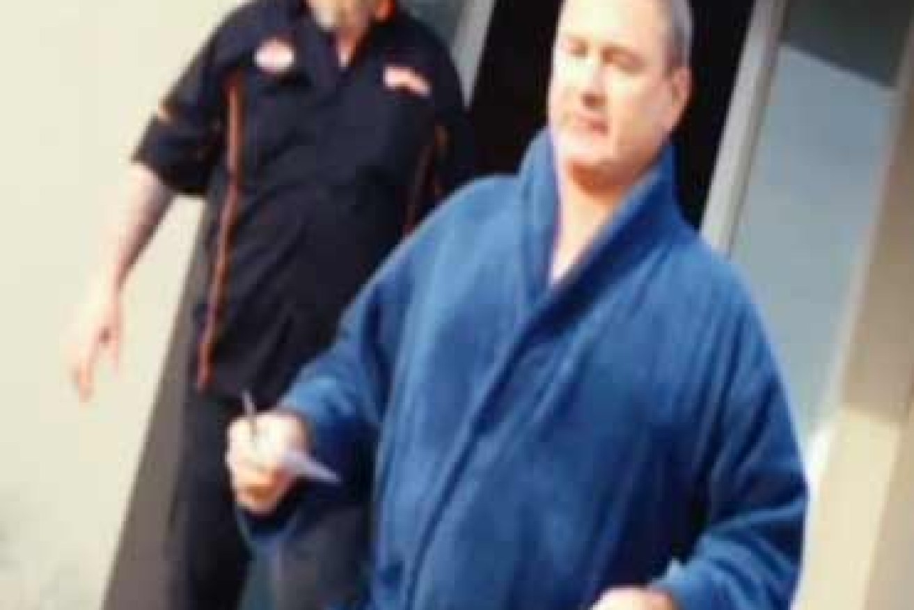 Baron in terry-toweling robe and one of his former colleagues on secret camera footage shown on A Current Affair. 