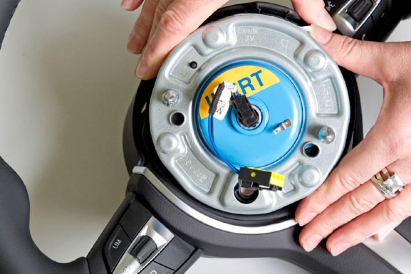A Takata airbag trigger - known technically as a "pyro-electric airbag initiator" nestles inside a steering wheel hub.