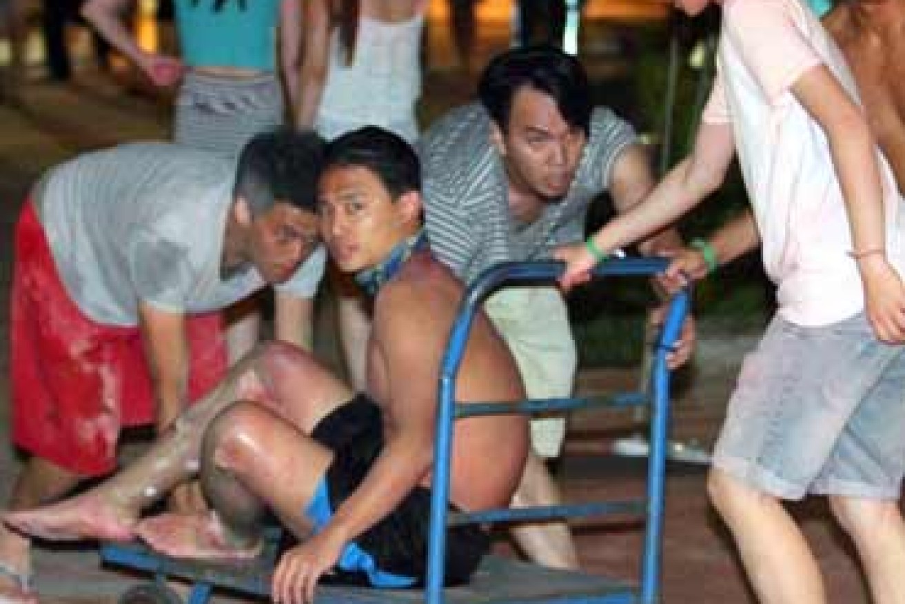 Revelers turned to rescuers as half a party engulfed in flames at water park. Photo: AAP